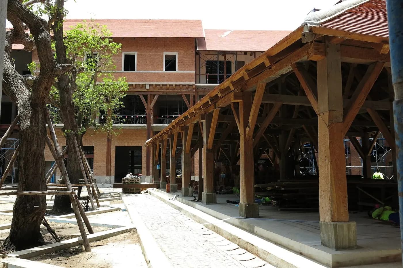 Tree-lined courtyard and timber colonnades at One Nimman in Chiang Mai
