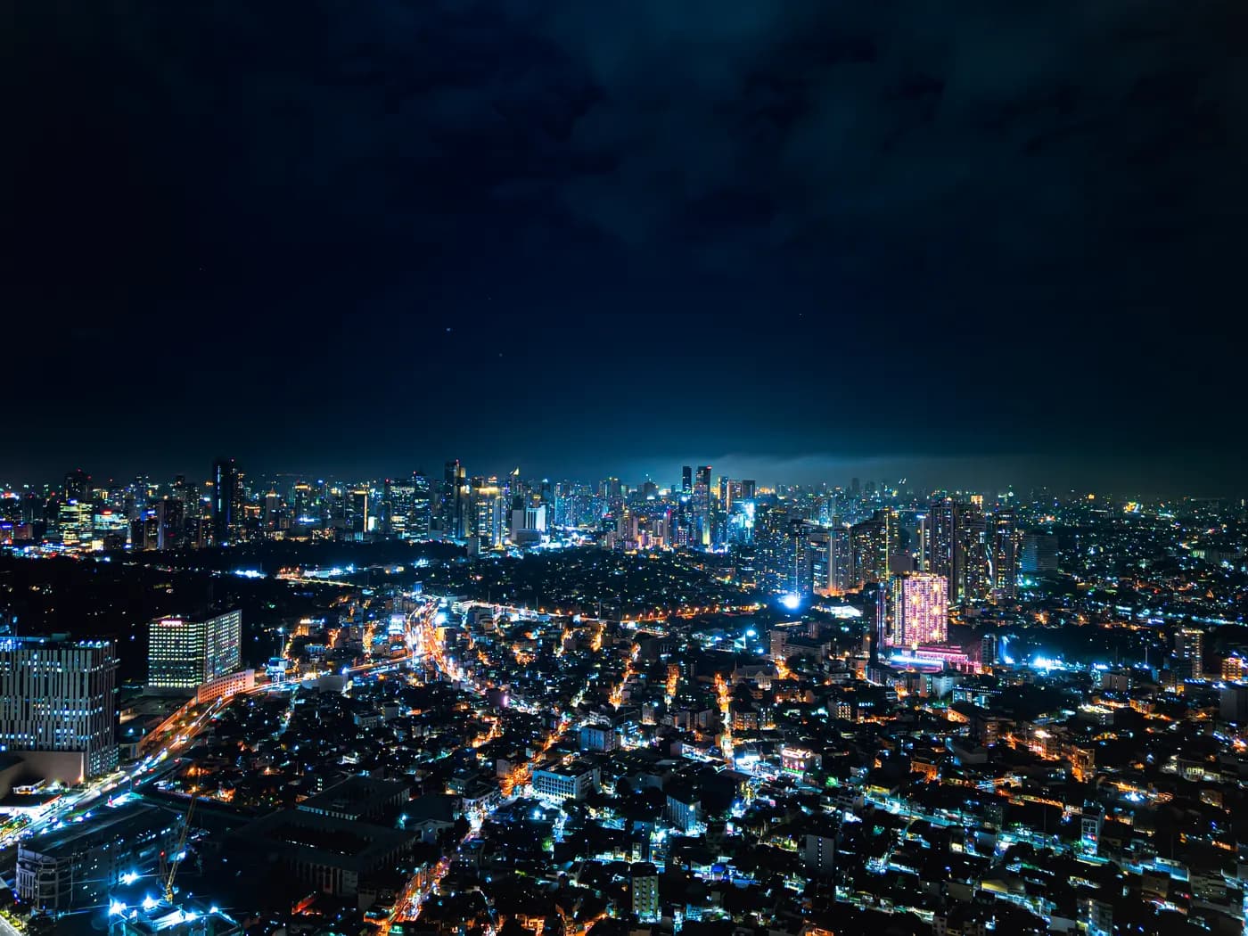 The illuminated Metro Manila skyline at night, photographed from Taguig City