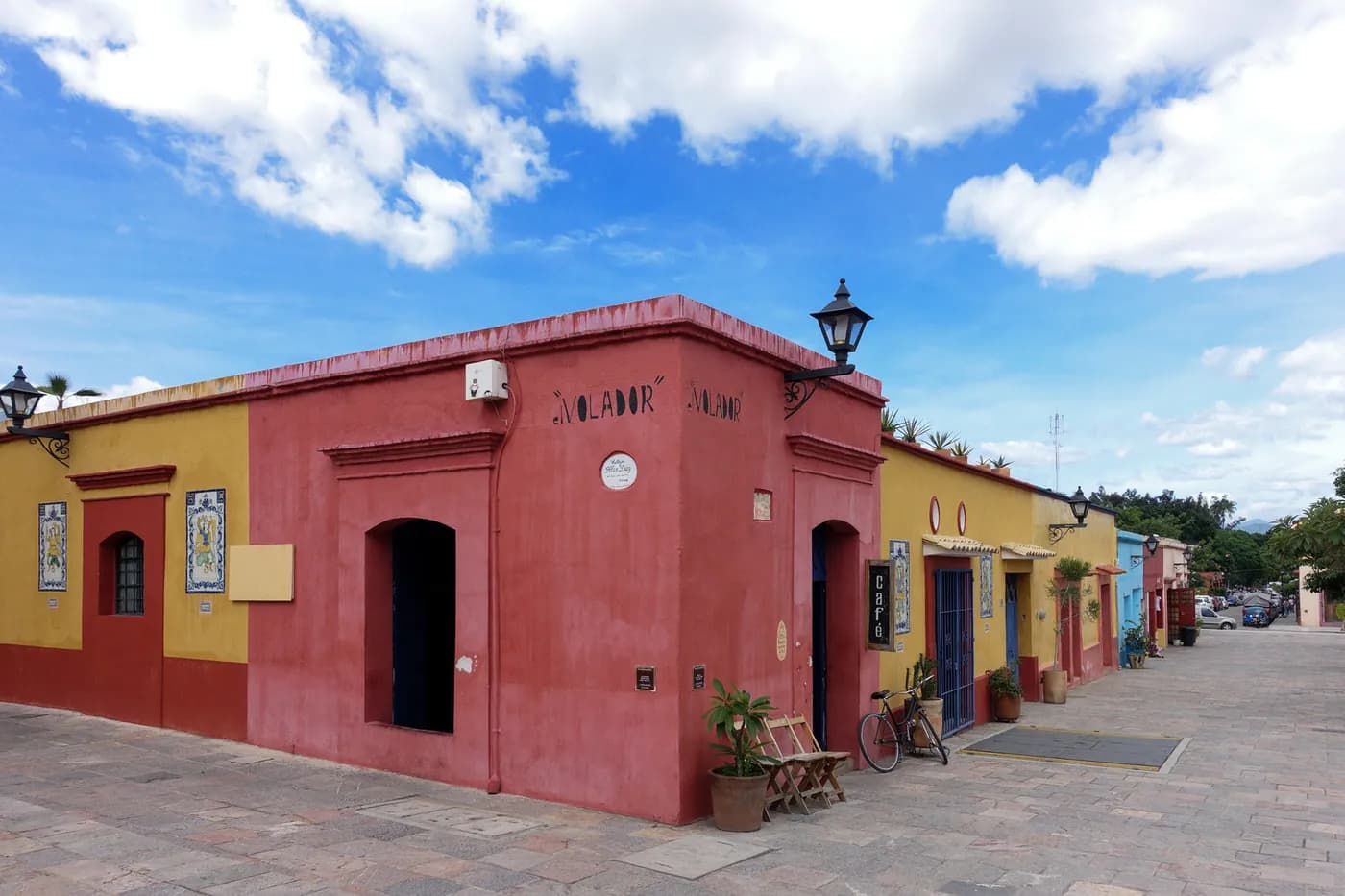 Colorful colonial buildings along a sunlit street in Oaxaca, Mexico