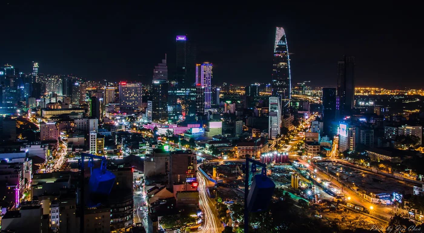 Illuminated towers and busy streets in central Ho Chi Minh City at night