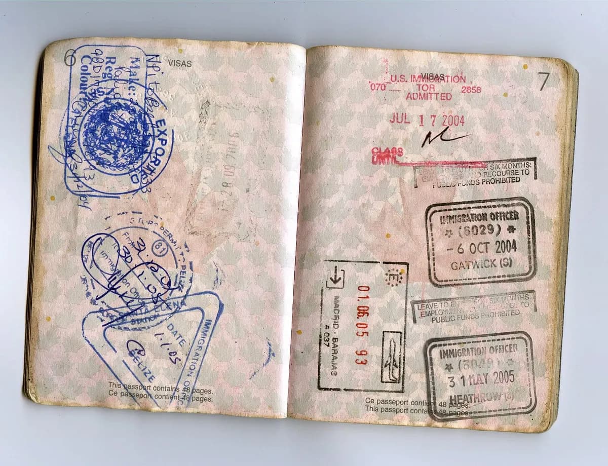 Open passport pages with historical immigration stamps, illustrating travel preparation